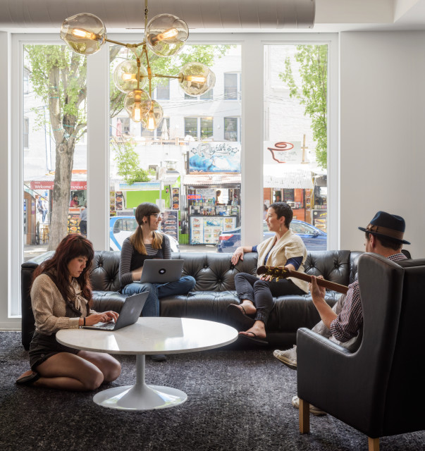 Floor-to-ceiling windows open this collaborative living room-style space to the SW 3rd and Washington food carts.